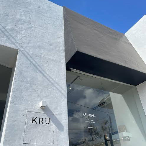 Modern building exterior with 'KRU' branding on a clear day